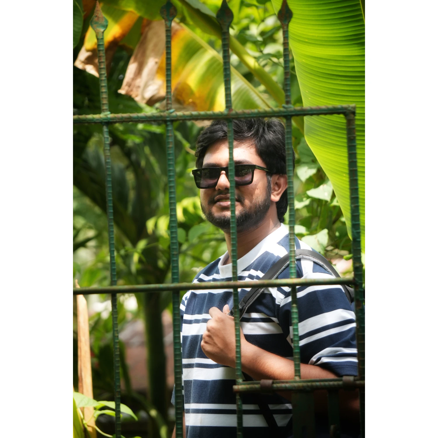 Riad capturing a unique perspective through a window frame in Bandarban