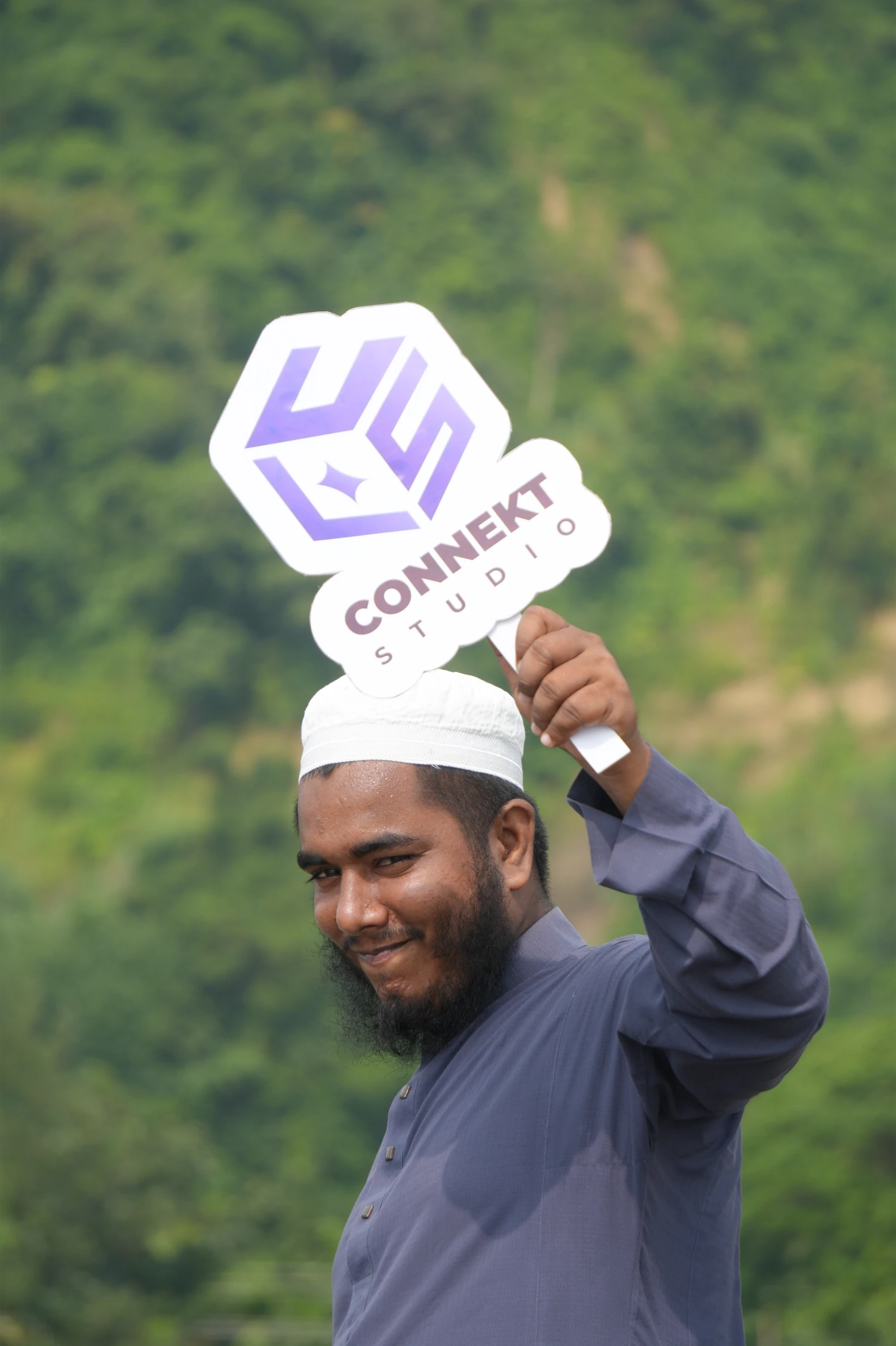 Moyen holding ConnektStudio card at Cox's Bazar beach retreat