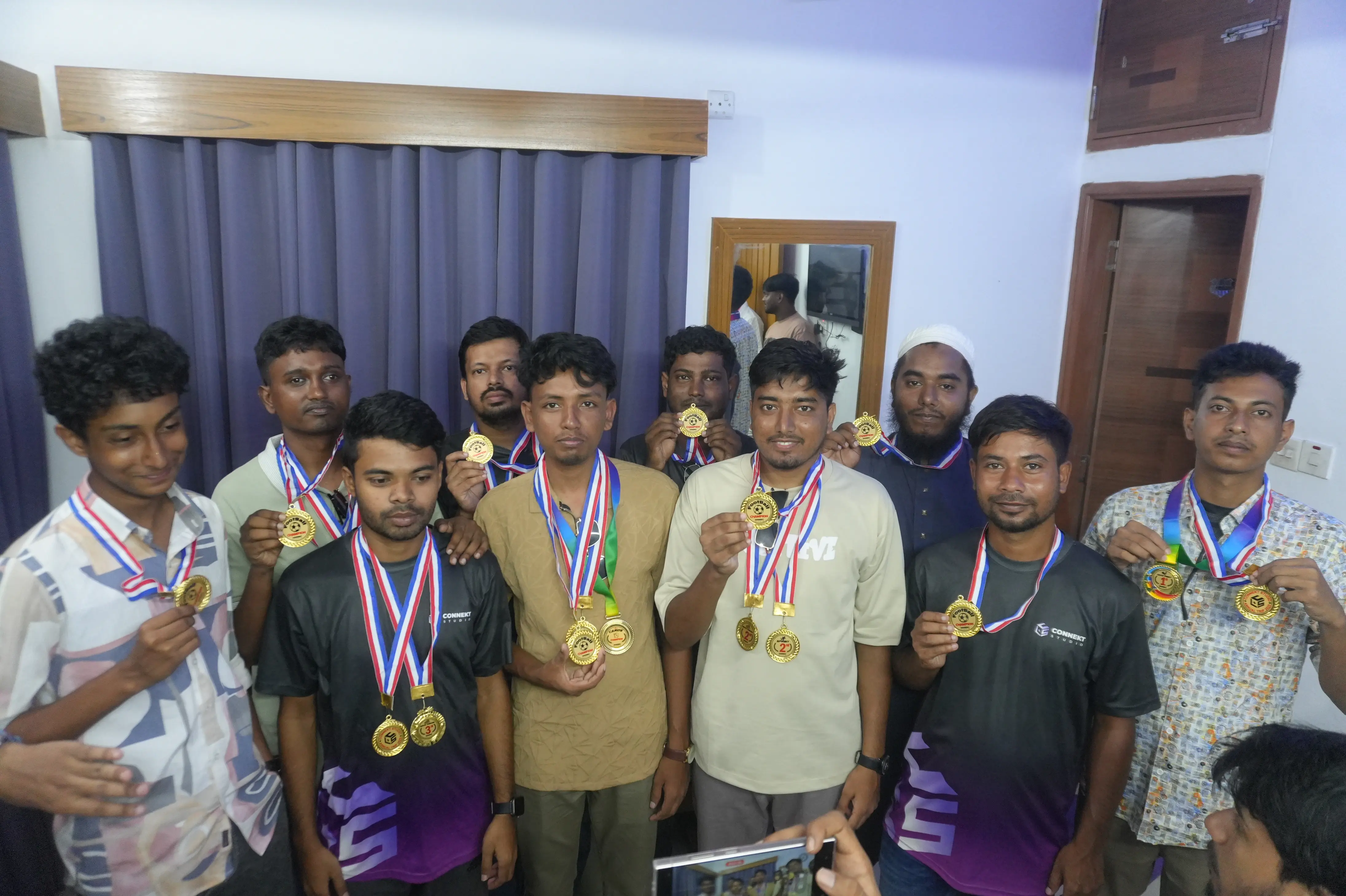 Team celebrating winning the tug of war game medal